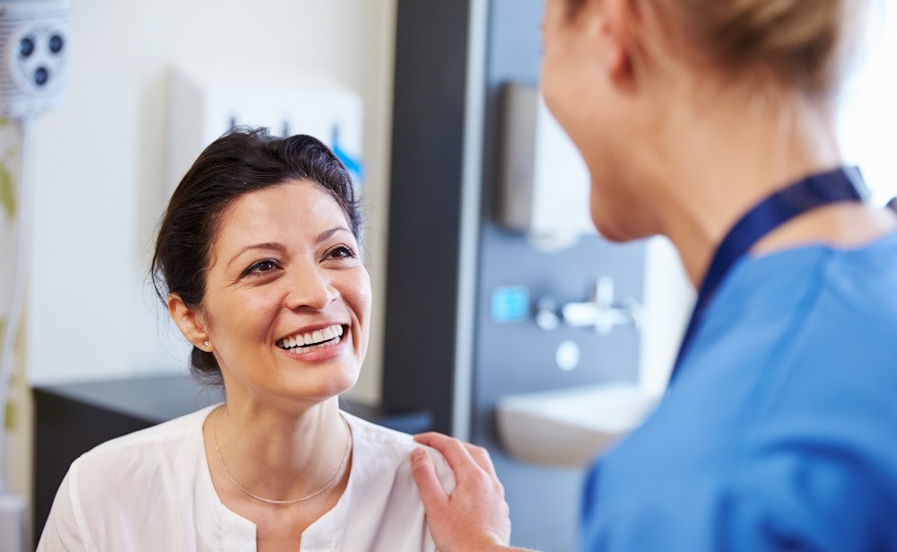 woman speaking with a doctor in an office