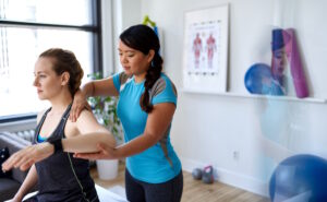 woman working her shoulder in physical therapy
