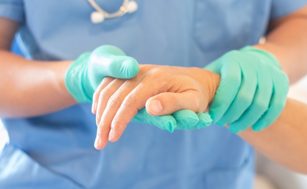 hand doctor checking patients hand