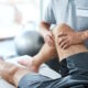 physical therapist stretching patients knee