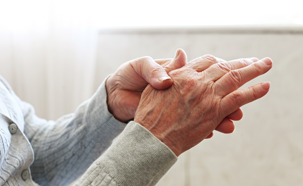 woman holding aching hand