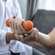 patient holding arm weight in physical therapy