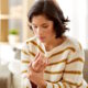 woman holding aching wrist