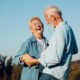 happy senior couple dancing outside