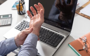 man holding hurting wrist