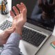 man holding hurting wrist