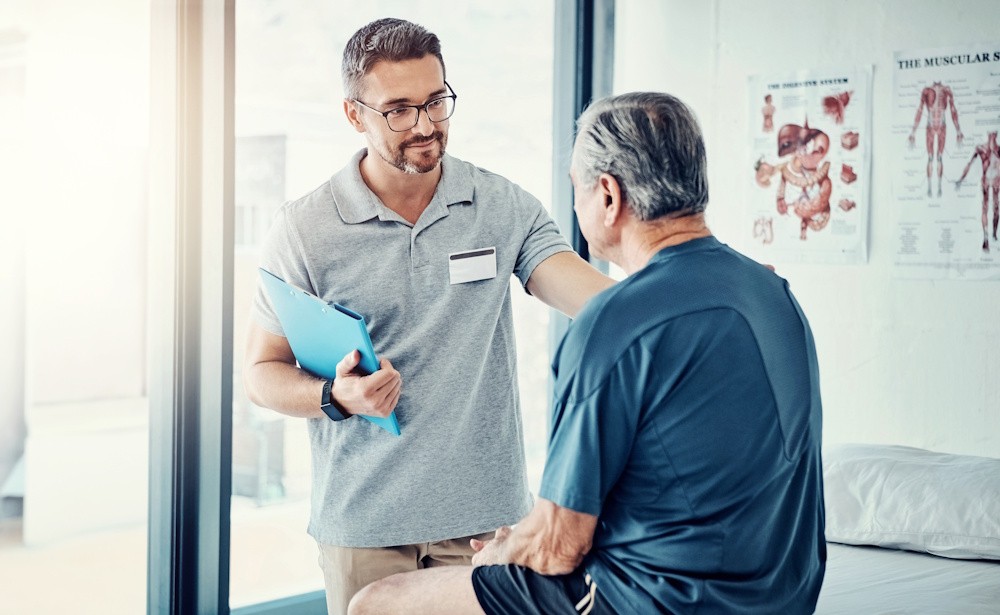 physical therapist consulting with patient