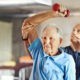 senior man exercising with physical therapist