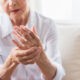 senior woman holding hurting hand
