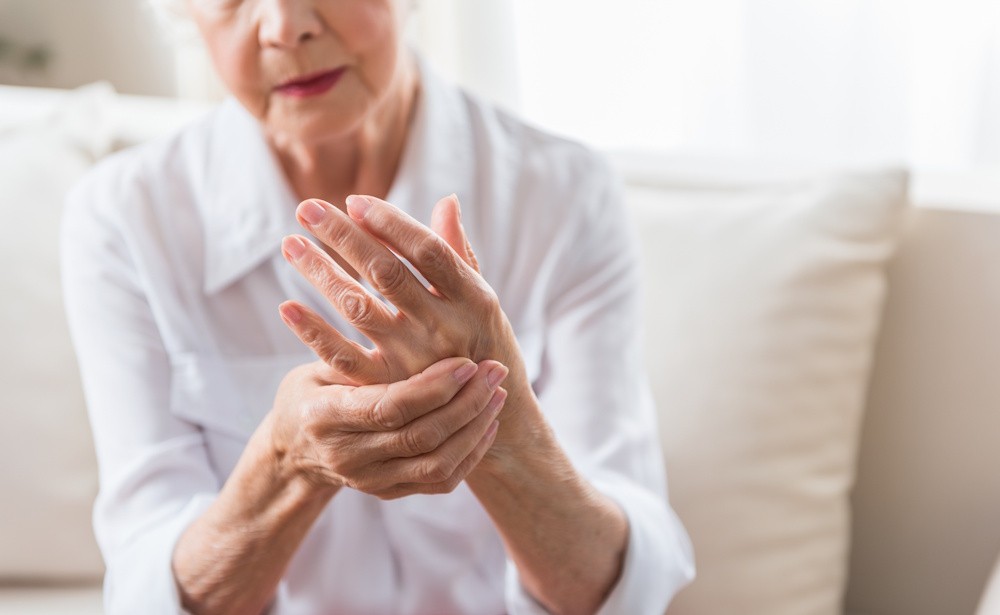senior woman holding hurting hand