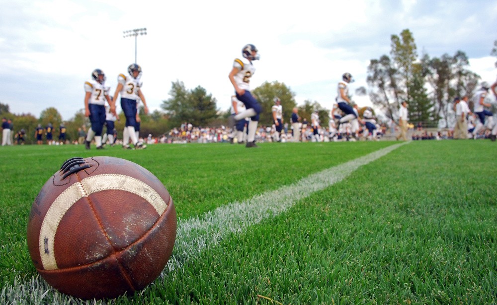 football players and ball on field