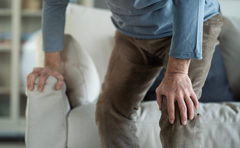 man holding hurting knee
