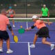 senior couple playing pickleballs