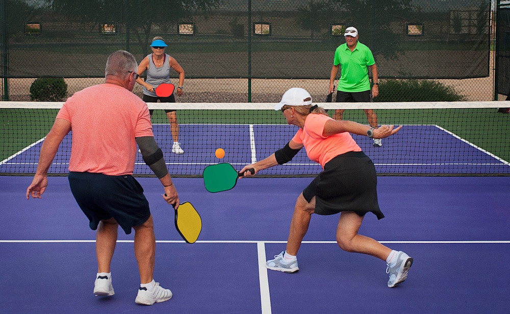 senior couple playing pickleballs