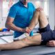 Rehabilitation therapy. Physiotherapist working with young male patient in the rehabilitation center.