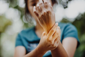 woman holding hurting hand