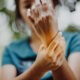 woman holding hurting hand